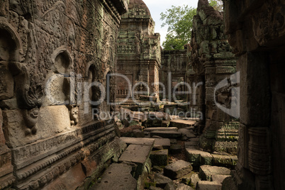 Fallen stone blocks littering ruined temple courtyard