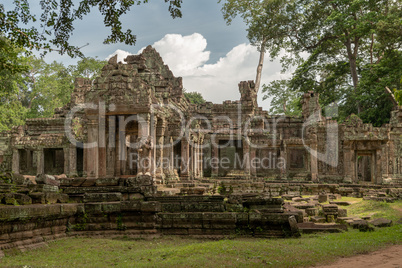 Front of Preah Khan framed by trees