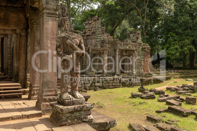 Headless statue and fallen blocks beside temple