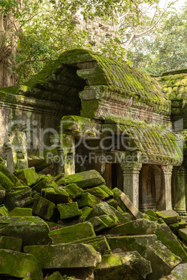 Moss-covered colonnade and roof behind fallen rocks