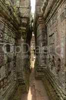 Narrow passage between leaning walls of temple