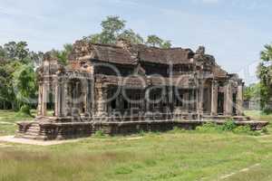 Ruined Angkor Wat stone temple in jungle