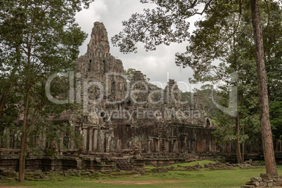 Ruined Bayon temple seen through the trees