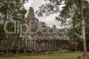 Ruined Bayon temple seen through the trees