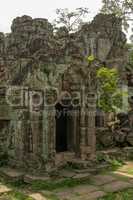 Ruined stone temple portico covered in lichen