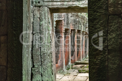 Ruined temple colonnade framed by twisted arch