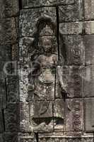 Statue of crowned woman in stone wall