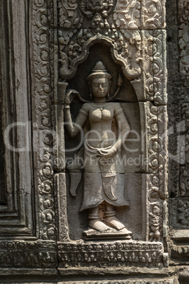 Statue of woman in decorated stone wall