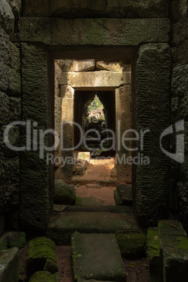 Stone corridor of temple leading towards trees