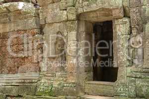 Stone doorway and bas-reliefs at ruined temple