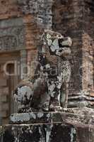 Stone lion covered in lichen guards temple