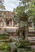 Stone lion guards entrance to Banteay Kdei
