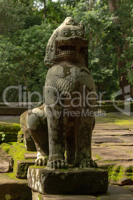 Stone lion guards entrance to Ta Prohm