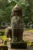 Stone lion guards entrance to Ta Prohm