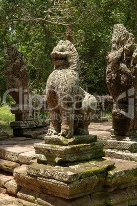 Stone lion statue between two snake heads