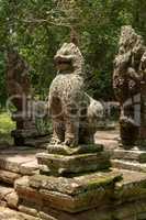Stone lion statue between two snake heads