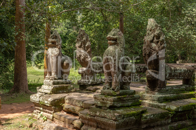 Stone lions and snakes guard Banteay Kdei