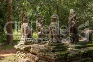 Stone lions and snakes guard Banteay Kdei