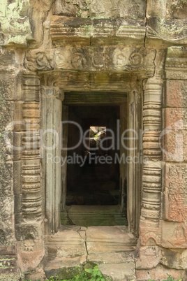 Stone temple doorway leading to fallen rocks