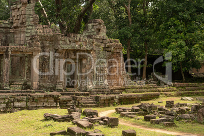 Stone temple with fallen blocks covering lawn