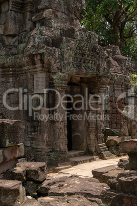 Temple doorway seen through gap in wall