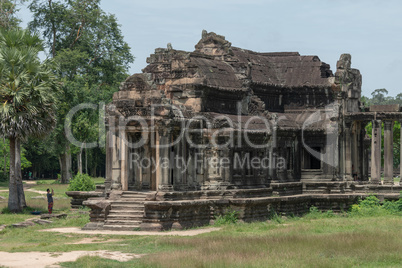 Tourist photographs ruined Angkor Wat stone temple