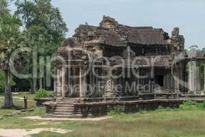 Tourist photographs ruined Angkor Wat stone temple