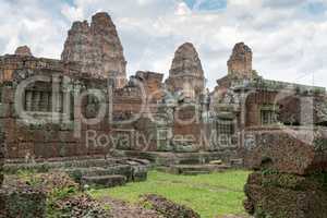 Towers of East Mebon behind stone wall