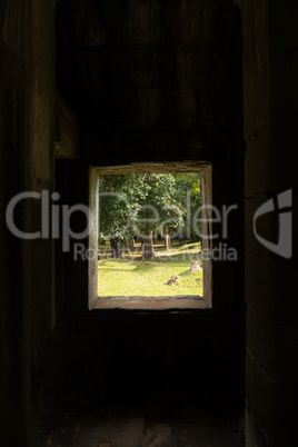 Trees seen through stone window in temple