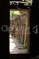 Twisted temple colonnade framed by stone arch