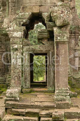 View through ruined temple entrance to forest