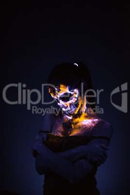 Girl's face painted UV skull