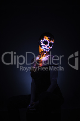 Girl's face painted UV skull