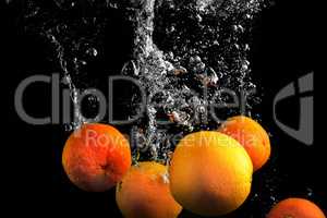 Clementines falling in water
