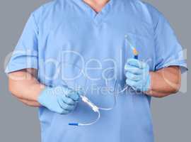 doctor with blue latex gloves and uniform holds medical equipmen