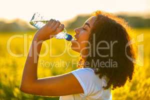 Mixed Race African American Girl Teenager Drinking Water at Suns