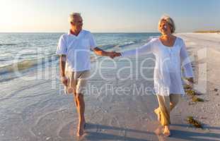 Happy Senior Couple Walking Holding Hands Tropical Beach