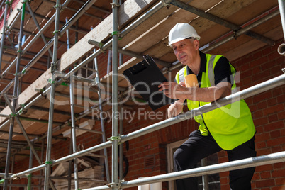Construction Foreman Builder on Building Site With Clipboard