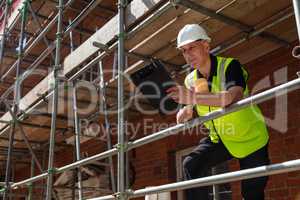 Construction Foreman Builder on Building Site With Clipboard