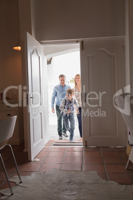 Happy family entering in home