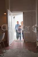 Happy family entering in home
