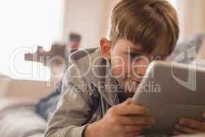 Boy using digital tablet in living room