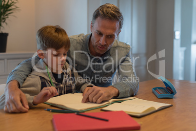 Father helping his son with his homework