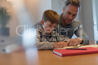 Father helping his son with his homework