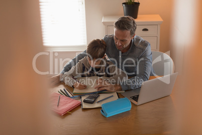 Father helping his son with his homework