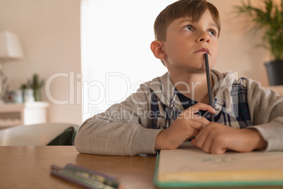 Boy doing his homework at home Boy doing his homework at home