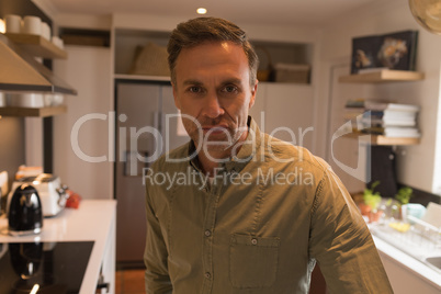 Man standing in kitchen at home