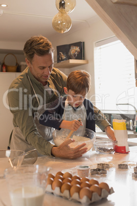 Father with his son preparing food in kitchen