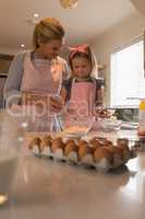 Mother baking cookies with daughter