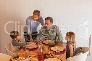 Family interacting with each other on dining table